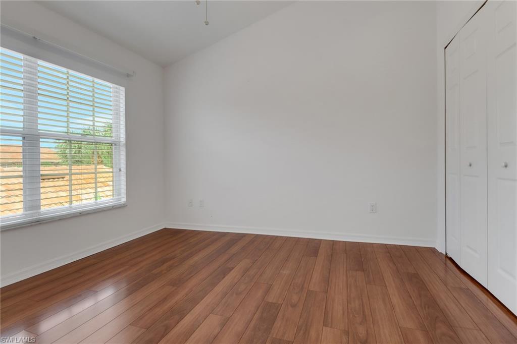 20141 Seagrove Street, Unit 308 Estero, FL 33928 - Photo 27 of 36 an empty room with wooden floor and windows