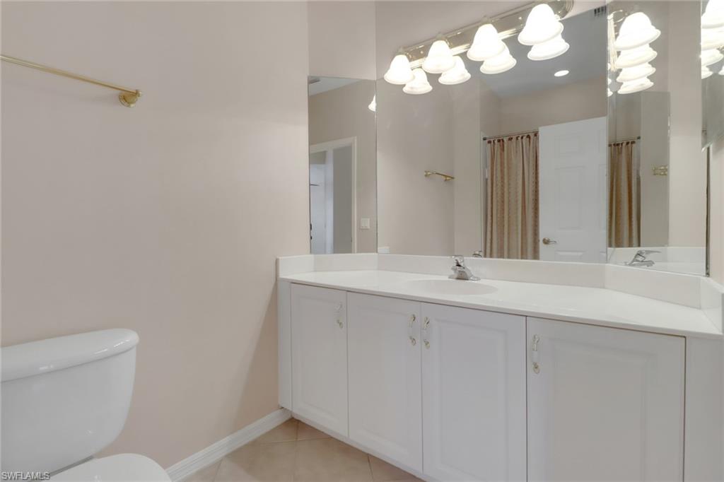 20141 Seagrove Street, Unit 308 Estero, FL 33928 - Photo 28 of 36 a bathroom with a sink and a mirror