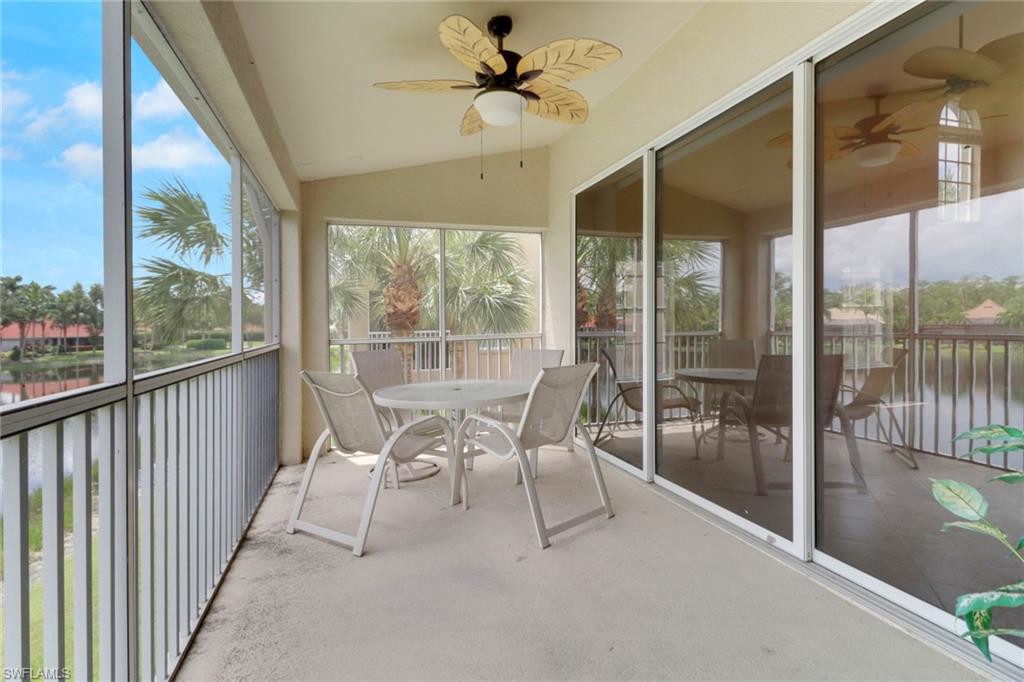 20141 Seagrove Street, Unit 308 Estero, FL 33928 - Photo 35 of 36 a dining room with furniture water view and a floor to ceiling window
