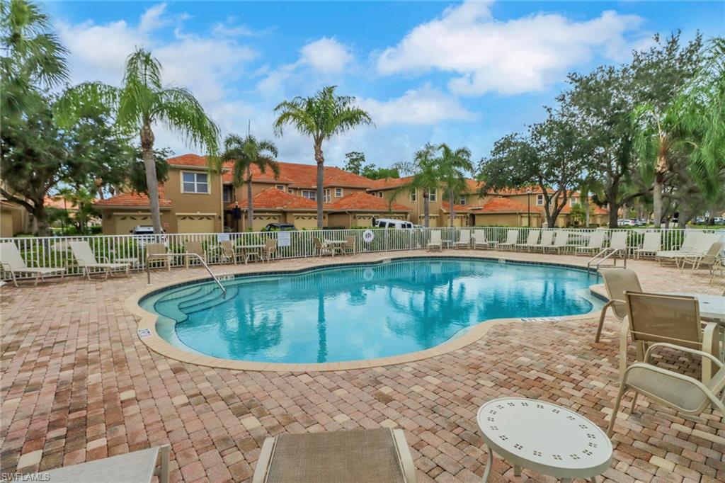 20141 Seagrove Street, Unit 308 Estero, FL 33928 - Photo 36 of 36 a swimming pool with outdoor seating and yard