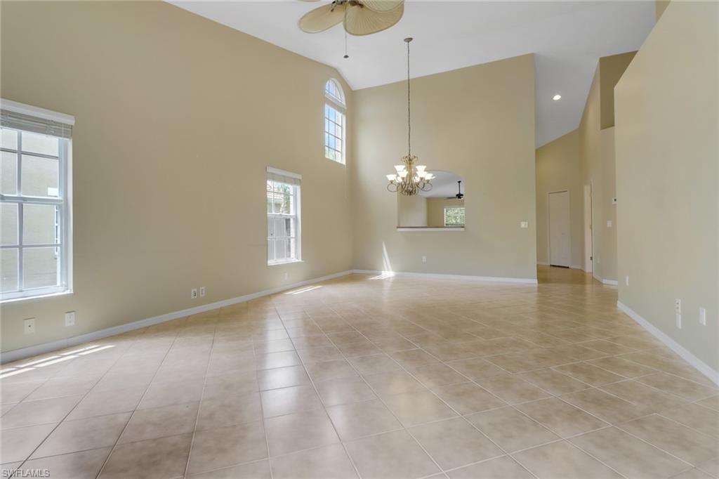 20141 Seagrove Street, Unit 308 Estero, FL 33928 - Photo 9 of 36 an empty room with kitchen and windows