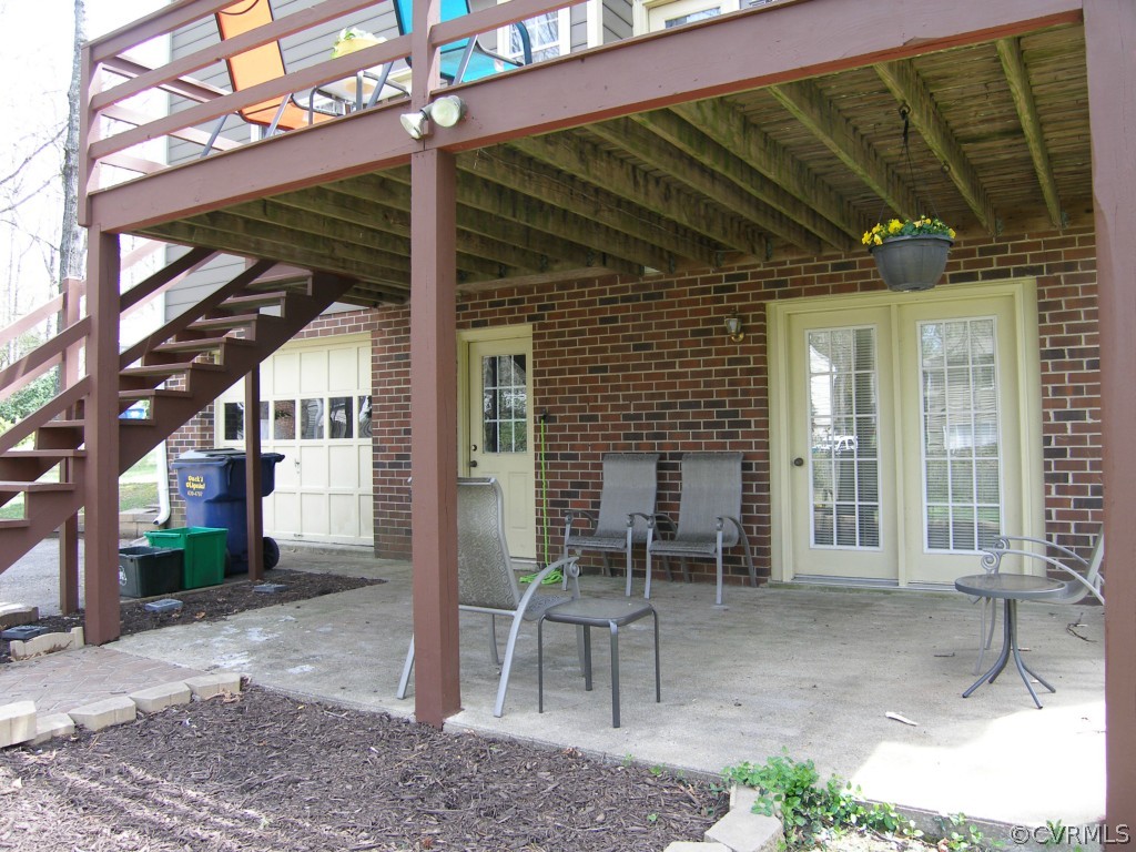 604 Fennimore Road Midlothian, VA 23114 - Photo 4 of 24 a view of a patio with table and chairs and a barbeque