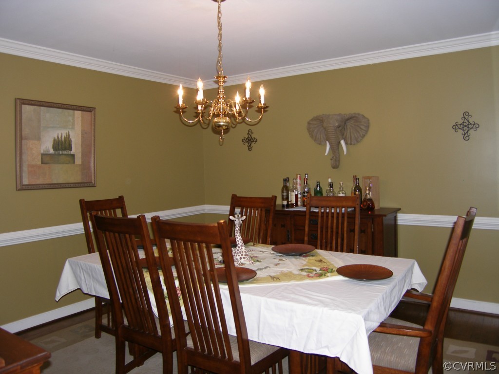 604 Fennimore Road Midlothian, VA 23114 - Photo 9 of 24 a view of a dining room with furniture a chandelier and wooden floor
