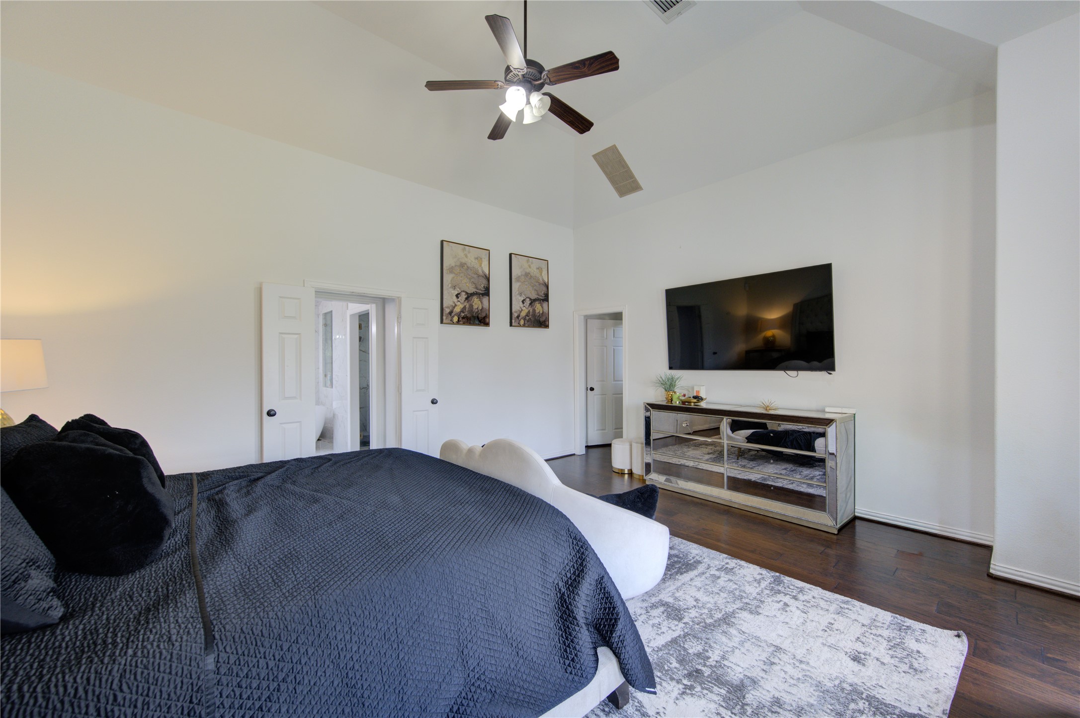 17539 Hankar Way Richmond, TX 77407 - Photo 16 of 34 a bedroom with a bed and a flat screen tv