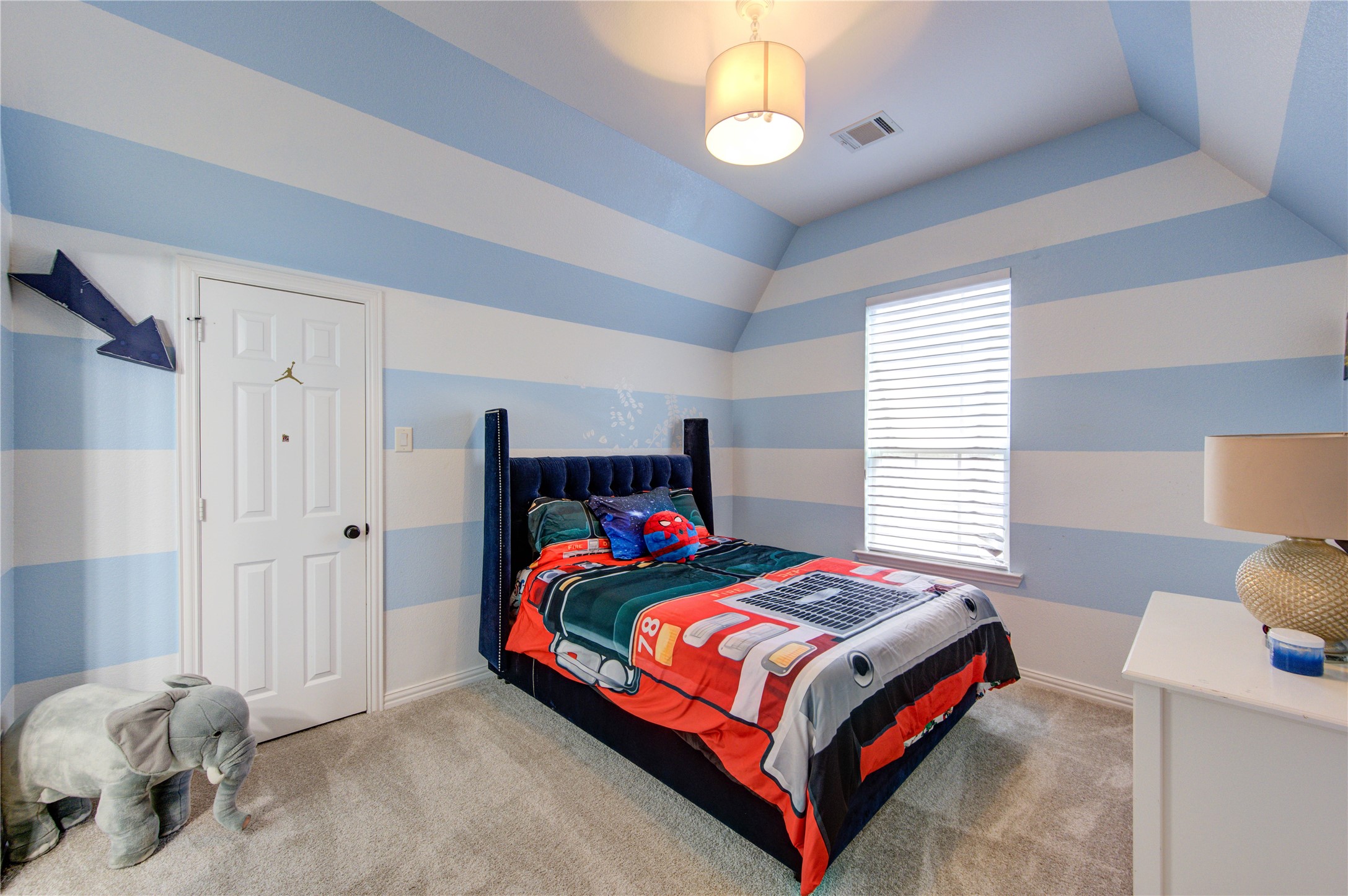 17539 Hankar Way Richmond, TX 77407 - Photo 25 of 34 a bedroom with a bed and a chandelier