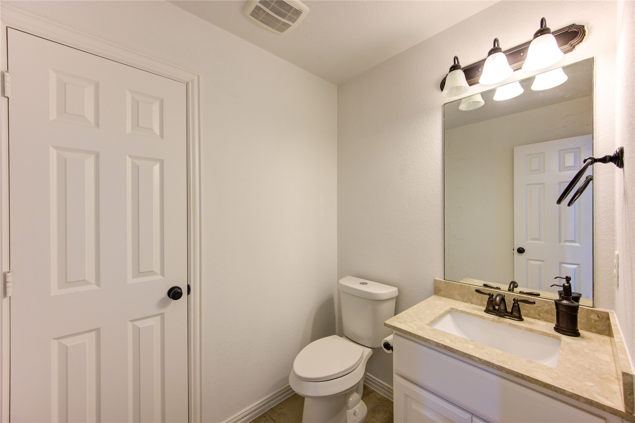 17539 Hankar Way Richmond, TX 77407 - Photo 26 of 34 a bathroom with a sink vanity mirror and toilet