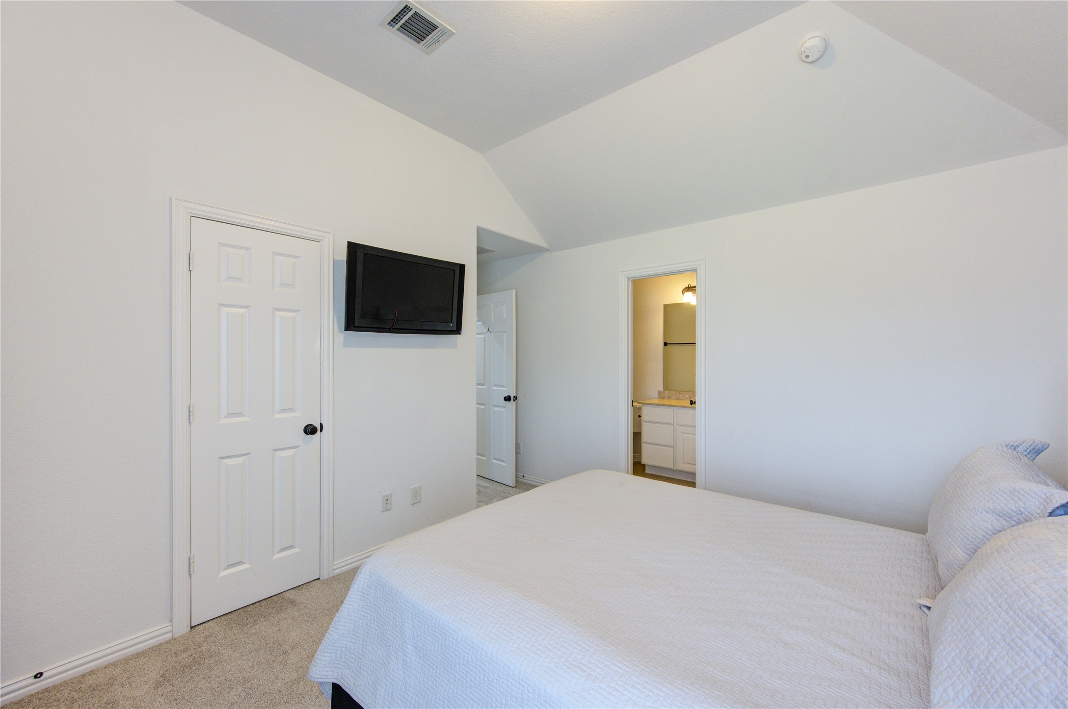 17539 Hankar Way Richmond, TX 77407 - Photo 29 of 34 a bedroom with a bed and a flat screen tv