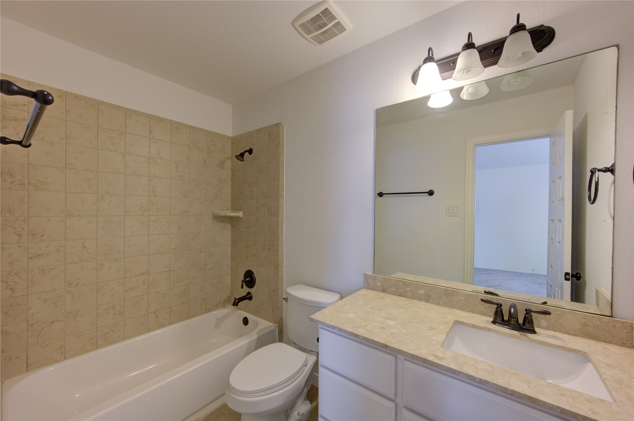 17539 Hankar Way Richmond, TX 77407 - Photo 30 of 34 a bathroom with a granite countertop sink mirror toilet and bathtub