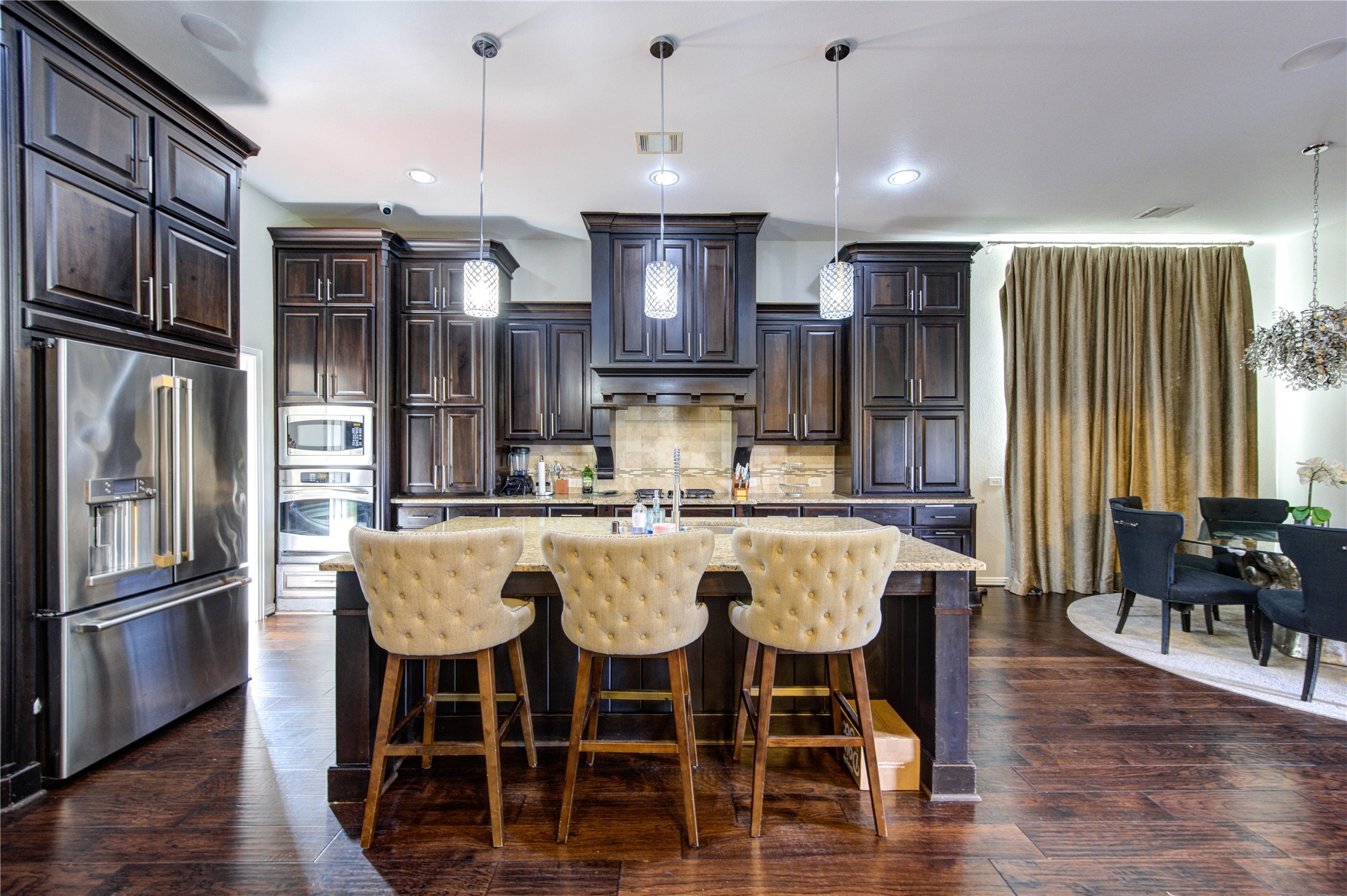 17539 Hankar Way Richmond, TX 77407 - Photo 3 of 34 a large kitchen with a table and chairs