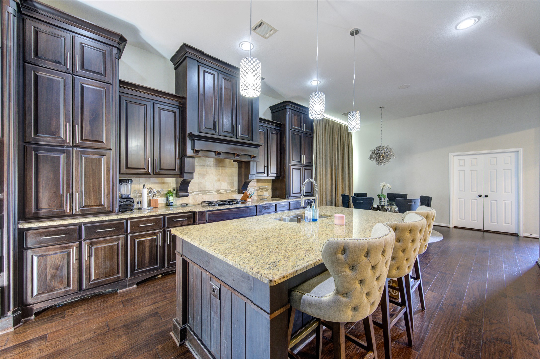 17539 Hankar Way Richmond, TX 77407 - Photo 4 of 34 a kitchen with granite countertop cabinets stainless steel appliances and wooden floor