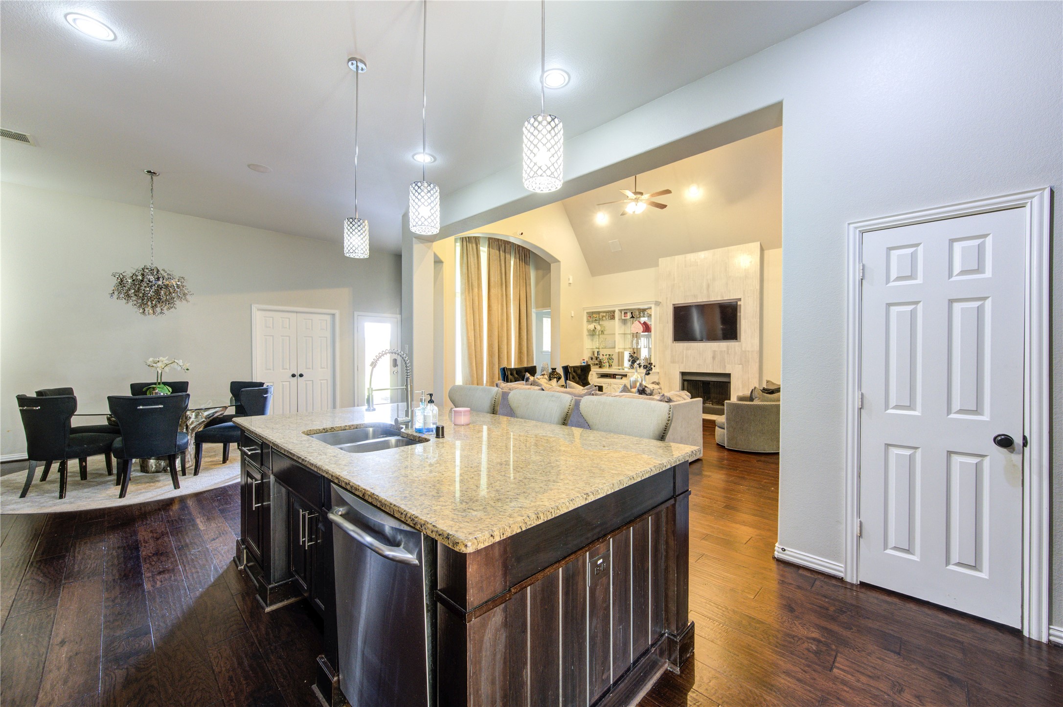 17539 Hankar Way Richmond, TX 77407 - Photo 6 of 34 a large kitchen with kitchen island a sink table and chairs