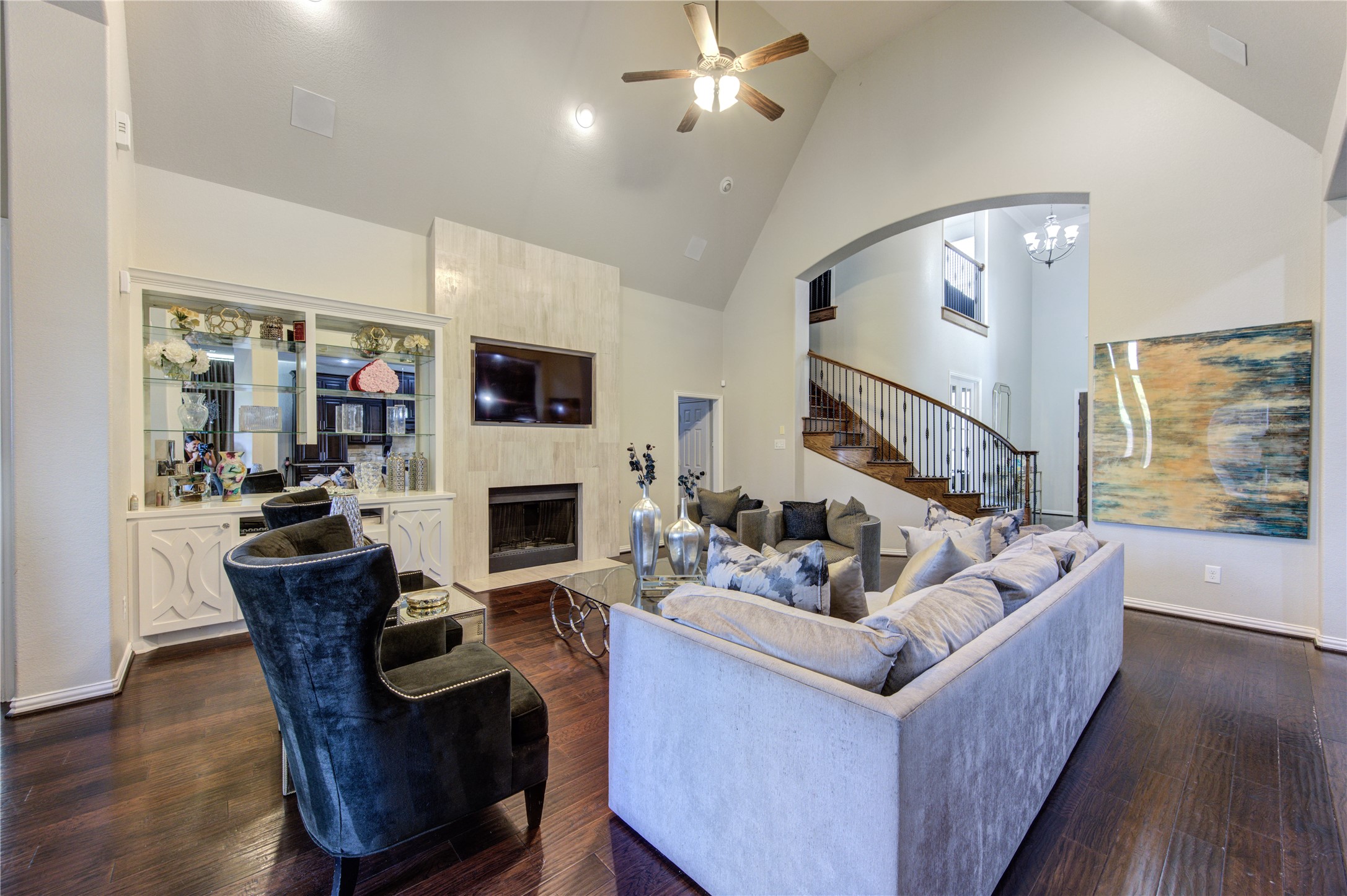 17539 Hankar Way Richmond, TX 77407 - Photo 9 of 34 a living room with furniture a fireplace and a flat screen tv