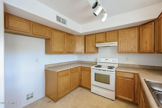 a kitchen with white cabinets and white appliances