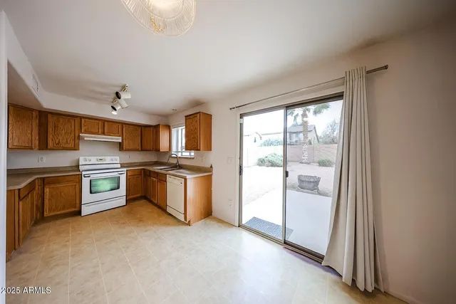 a large kitchen with cabinets and stainless steel appliances