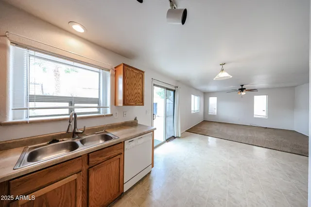 a kitchen with granite countertop a sink and a window