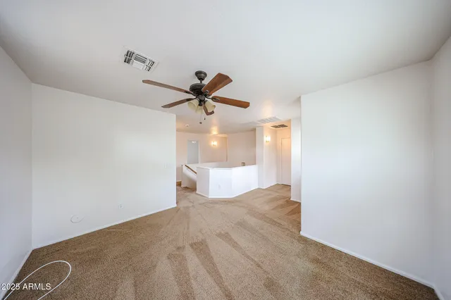 a view of a big room with a ceiling fan