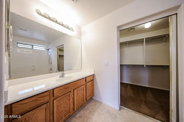 a bathroom with a double vanity sink and mirror