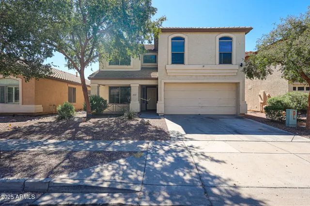a view of a white house with a yard