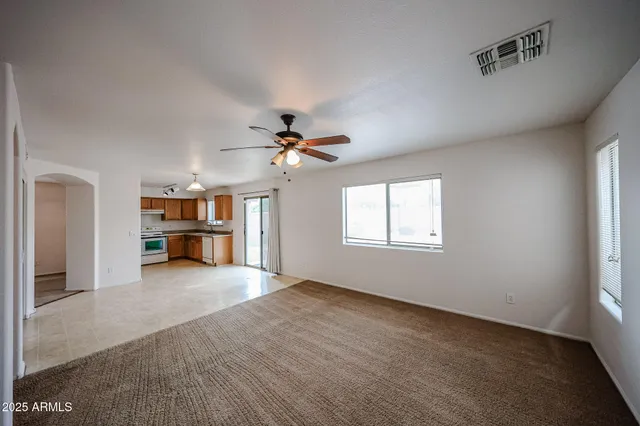 a view of a livingroom with a ceiling fan and window