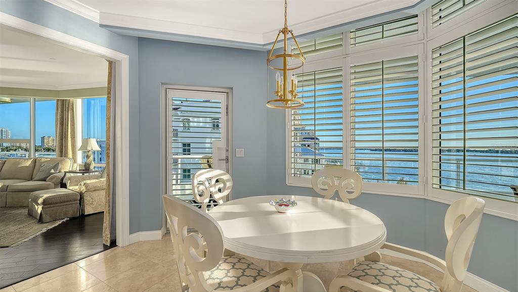 136 Golden Gate Point, Unit 502 Sarasota, FL 34236 - Photo 11 of 38 a dining room with furniture and large windows