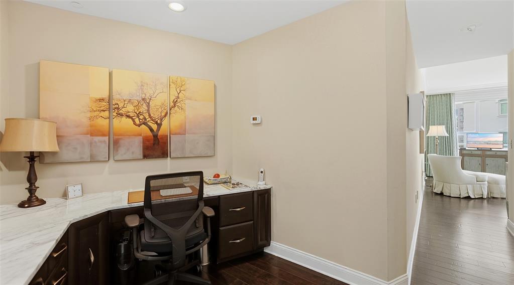 136 Golden Gate Point, Unit 502 Sarasota, FL 34236 - Photo 21 of 38 a view of a workspace with furniture and wooden floor