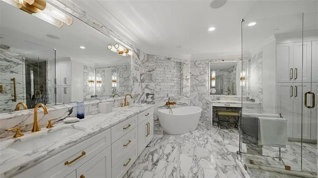 a large bathroom with a large mirror vanity shower and sink