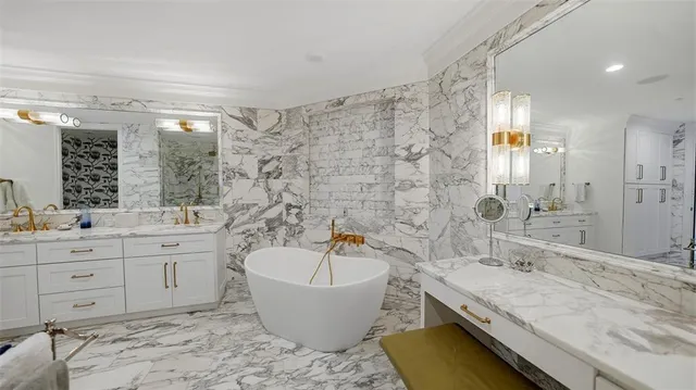 a spacious bathroom with a granite countertop sink and a bathtub