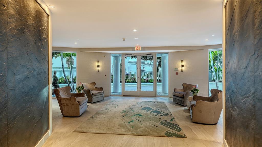 136 Golden Gate Point, Unit 502 Sarasota, FL 34236 - Photo 27 of 38 a living room with furniture rug and large windows