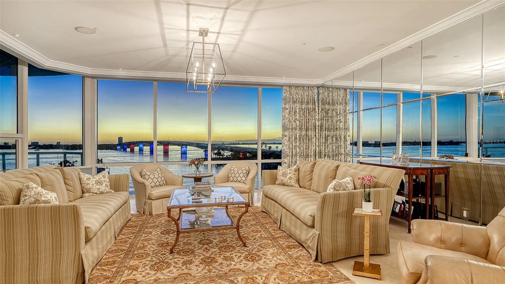136 Golden Gate Point, Unit 502 Sarasota, FL 34236 - Photo 5 of 38 a living room with furniture kitchen view and a chandelier