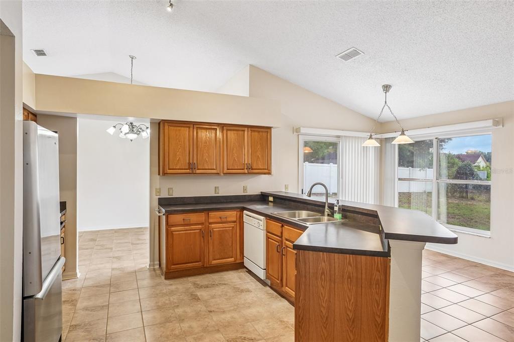 2596 Alclobe Circle Ocoee, FL 34761 - Photo 20 of 70 a kitchen with stainless steel appliances granite countertop a sink stove and refrigerator