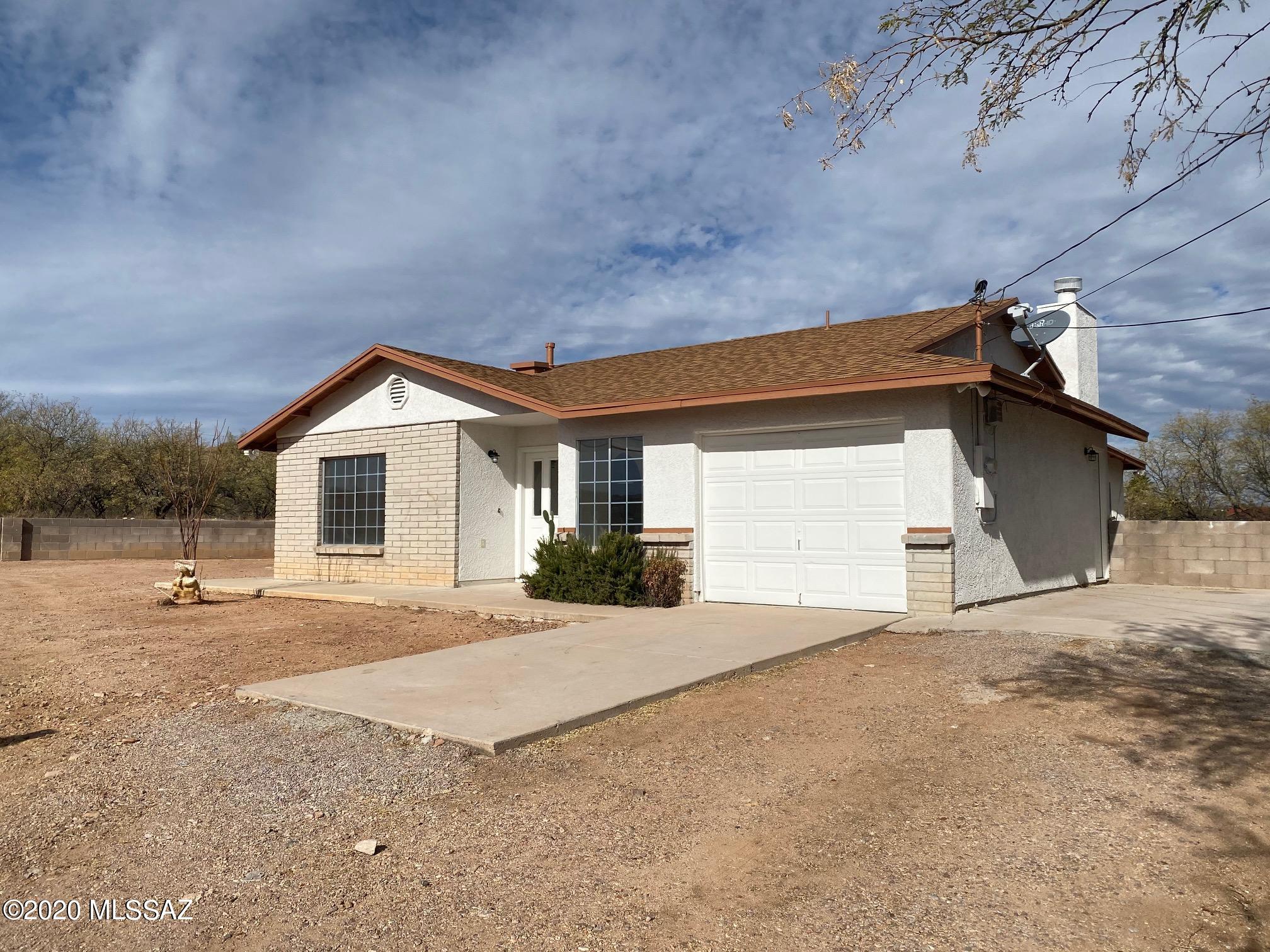 230 Camino Turmalina Rio Rico, AZ 85648 - Photo 2 of 15 a view of a house with backyard and a garage