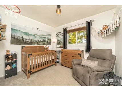 a bedroom with furniture and a baby crib