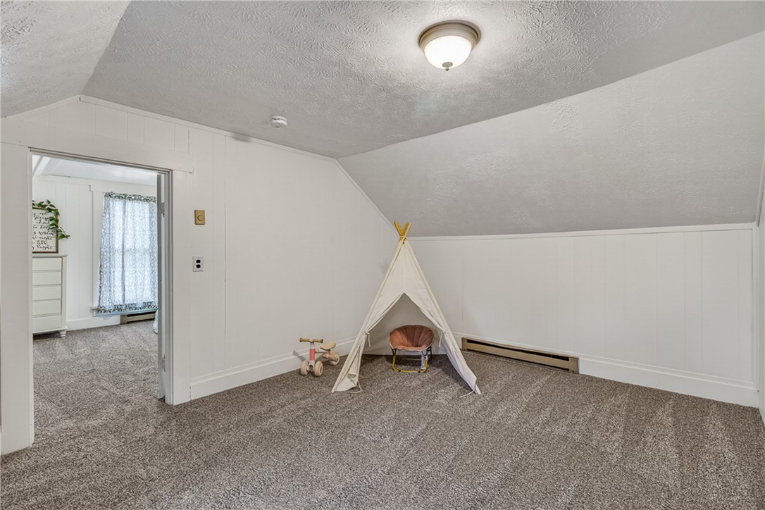 8700 Quaker Trace Road Camden, OH 45311 - Photo 19 of 34 This cozy room features soft carpeting and sloped ceilings, perfect for a private retreat.