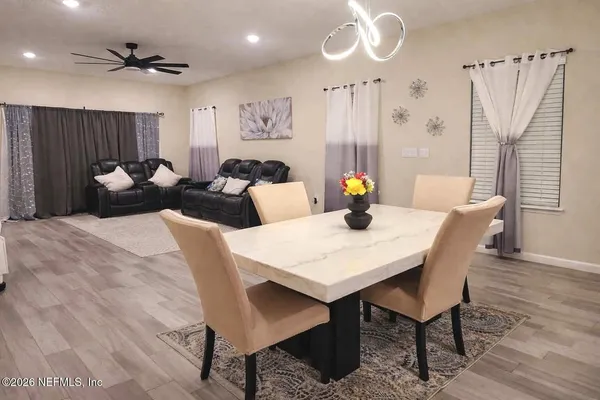 a view of a dining room with furniture and wooden floor