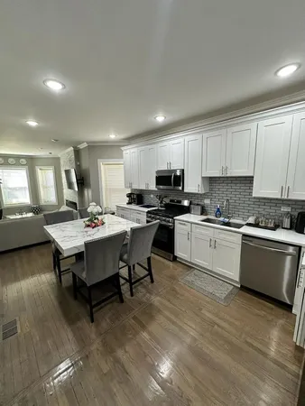 a kitchen with a table chairs sink and microwave