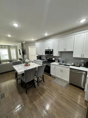 a kitchen with a table chairs sink and microwave