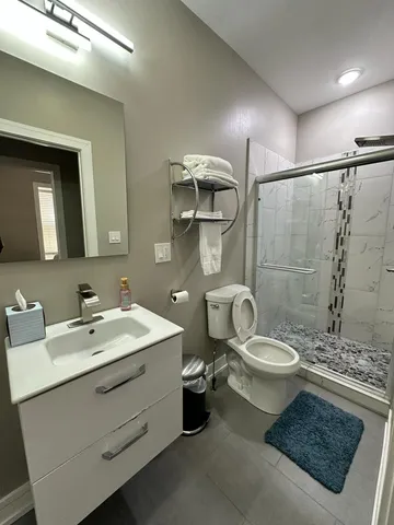 a bathroom with a toilet sink and mirror