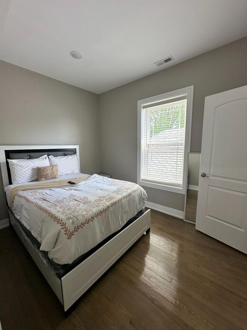 6807 South Calumet Avenue, Unit 1 Chicago, IL 60637 - Photo 9 of 17 a bedroom with a bed and a window