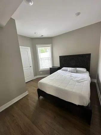 a bed sitting in a bedroom next to a window