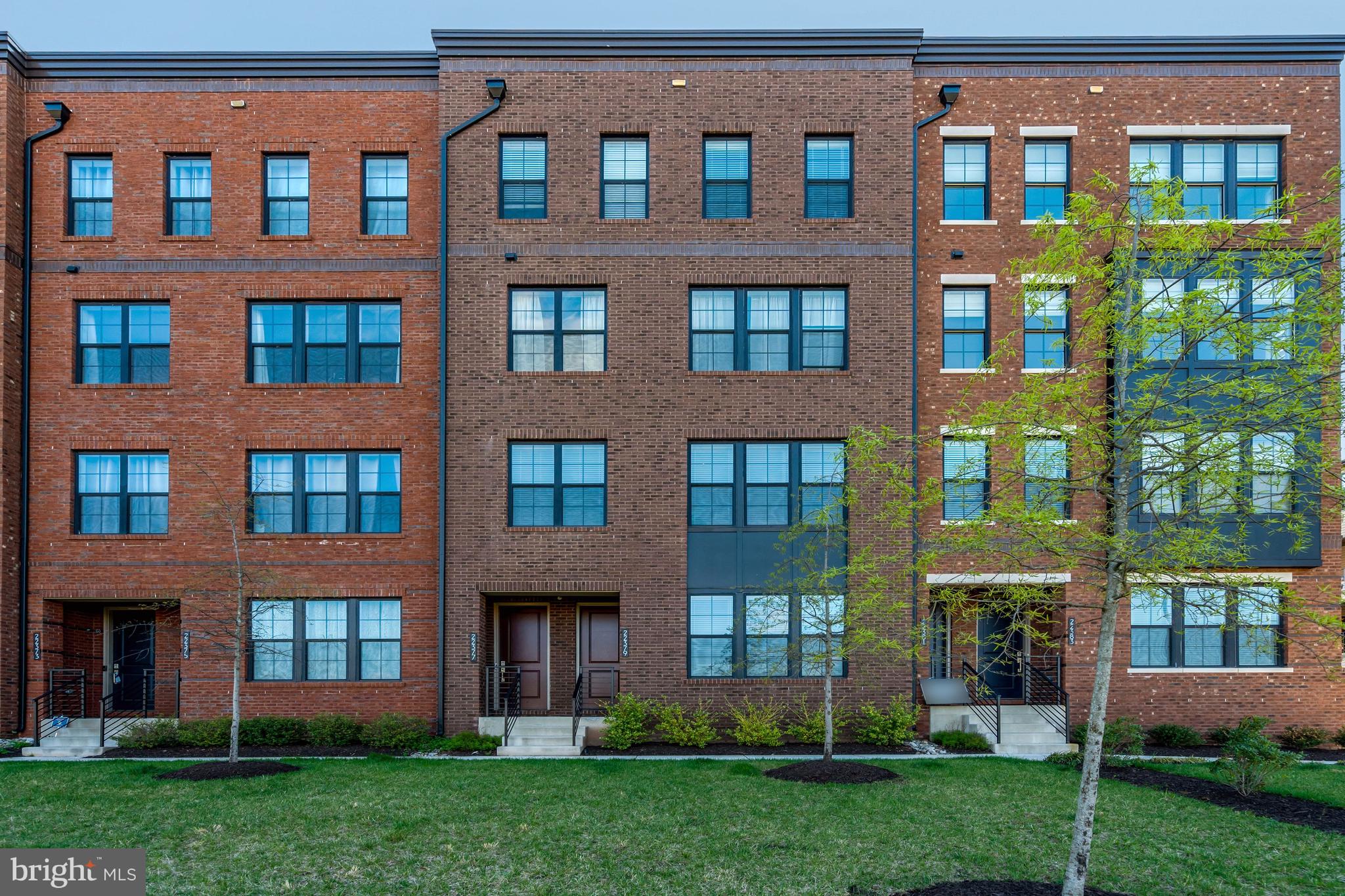 a front view of a building with a yard