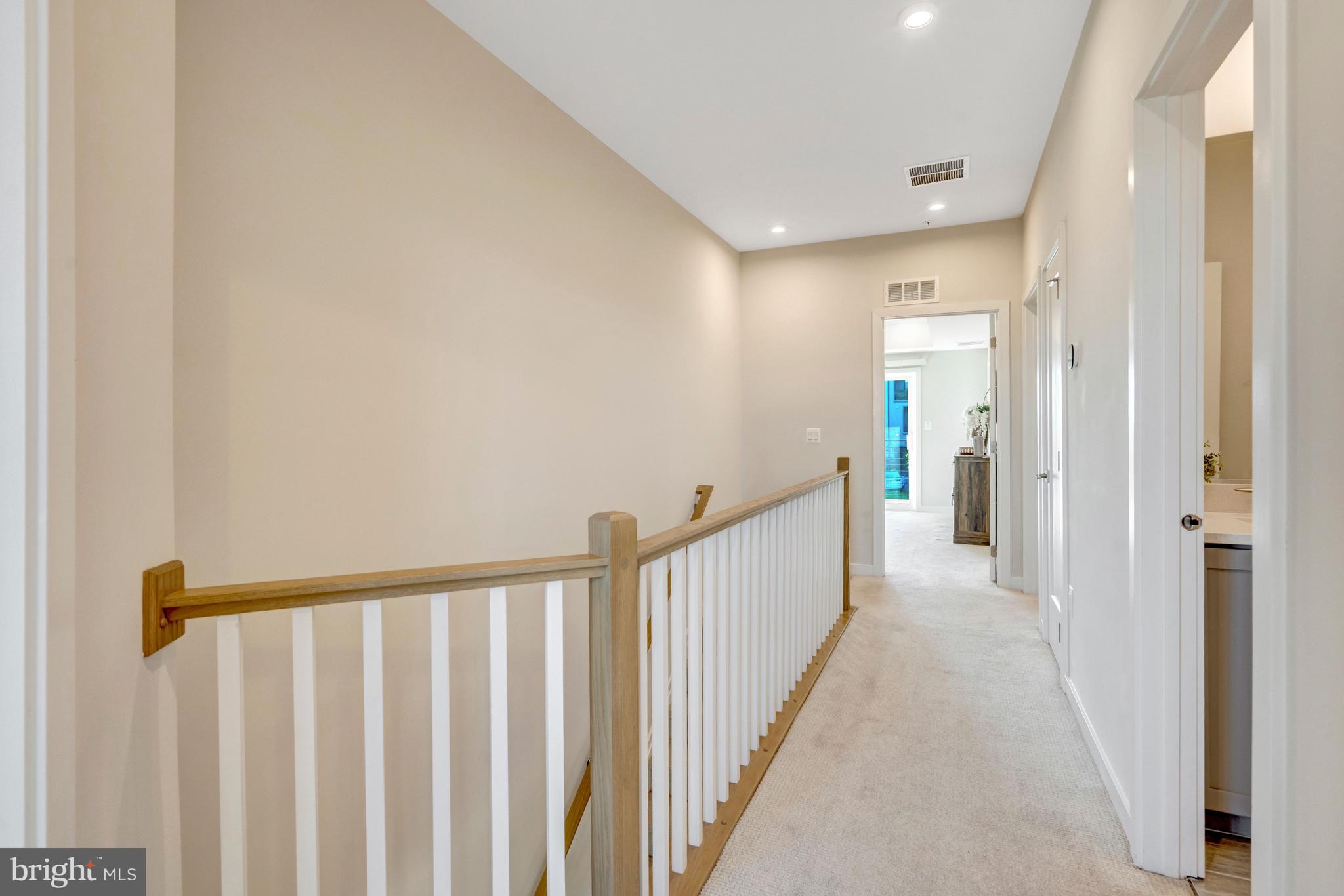 22379 Roanoke Rise Terrace Ashburn, VA 20148 - Photo 15 of 40 a view of a hallway with wooden floor