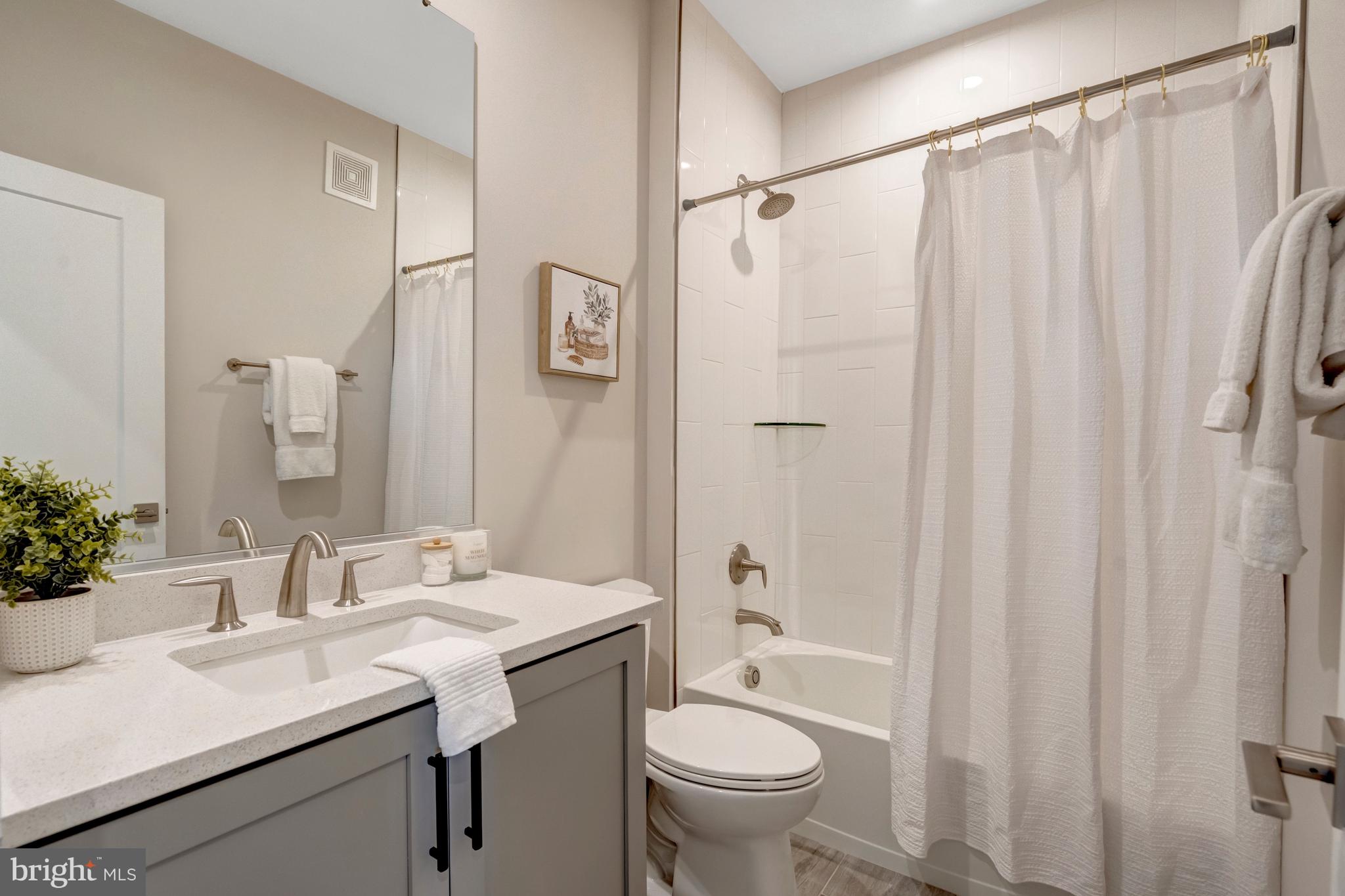 22379 Roanoke Rise Terrace Ashburn, VA 20148 - Photo 20 of 40 a bathroom with a sink toilet a mirror a vanity and shower