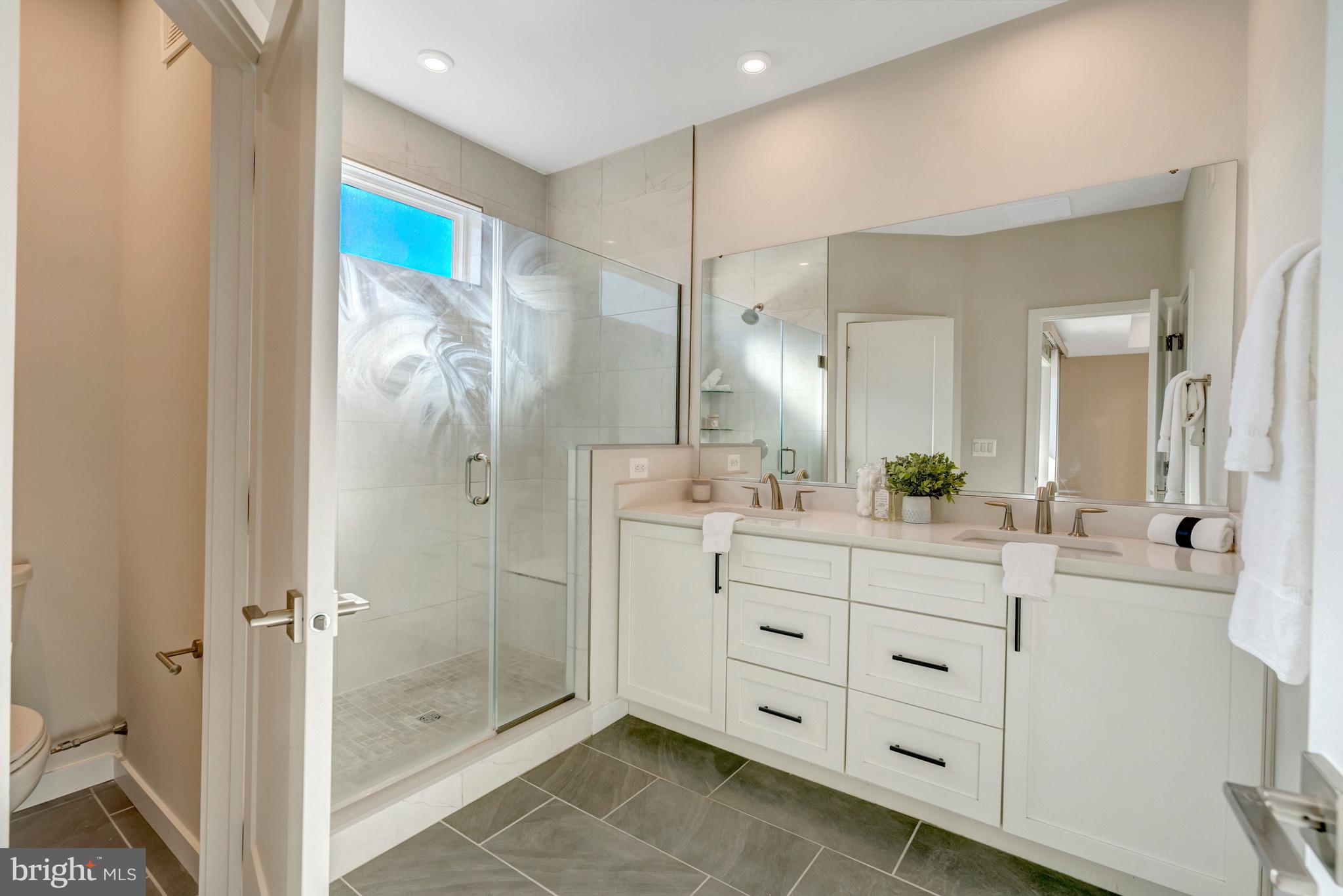 22379 Roanoke Rise Terrace Ashburn, VA 20148 - Photo 26 of 40 a bathroom with a double vanity sink mirror and double