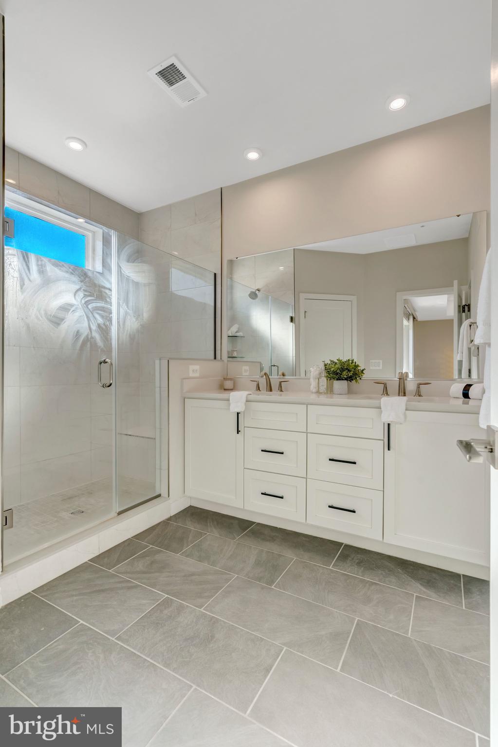 22379 Roanoke Rise Terrace Ashburn, VA 20148 - Photo 28 of 40 a bathroom with a mirror sink and shower
