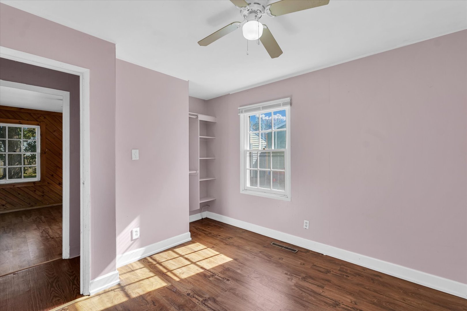 1710 Parkside Terrace Champaign, IL 61821 - Photo 19 of 31 a view of an empty room with a window and wooden floor