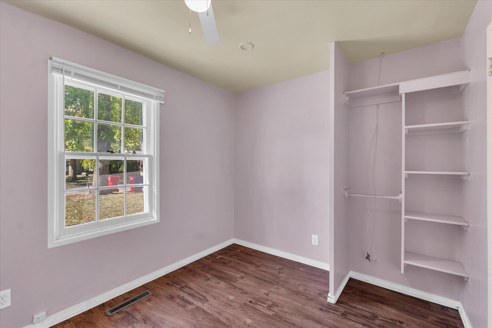 1710 Parkside Terrace Champaign, IL 61821 - Photo 22 of 31 a view of an empty room with a window and wooden floor