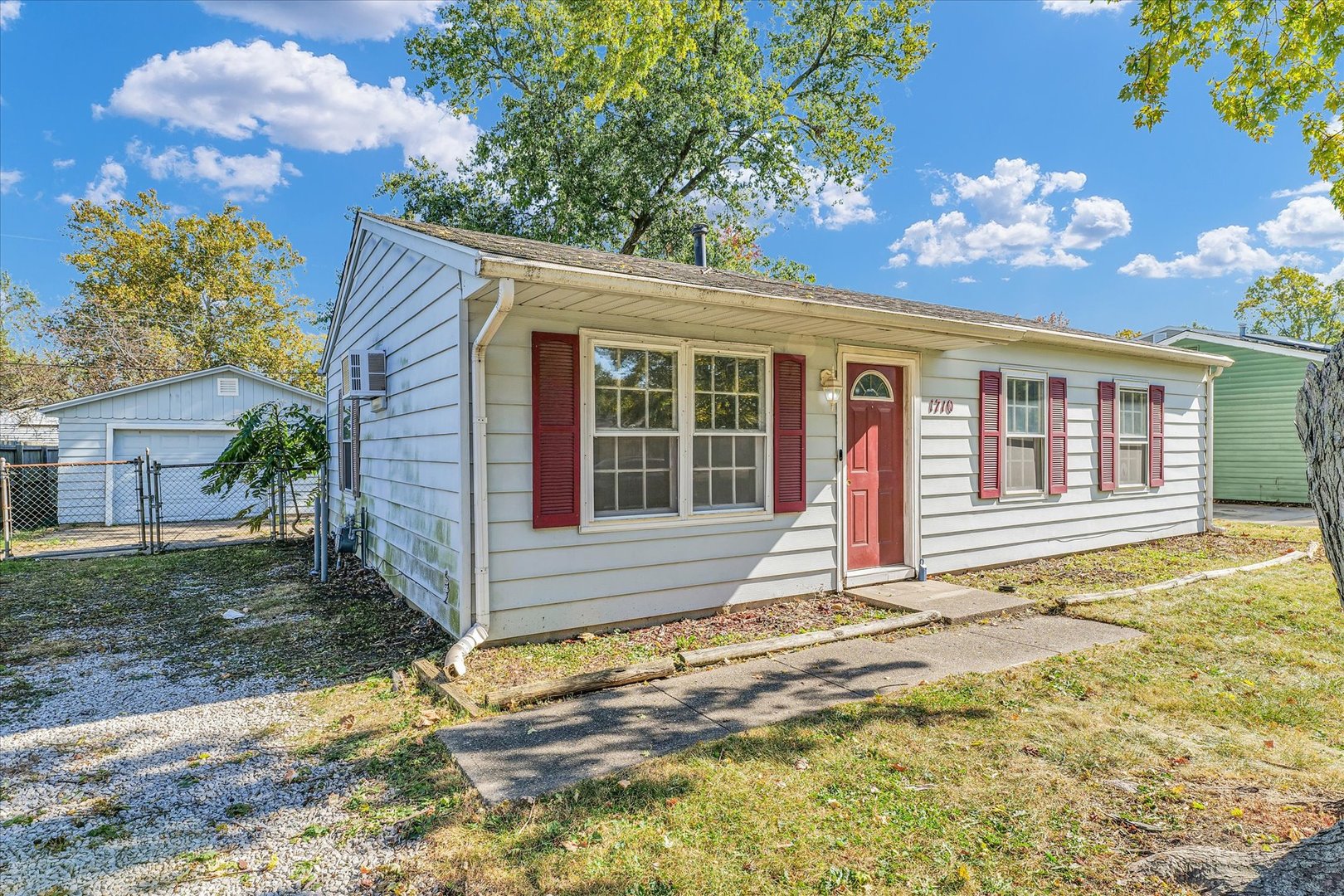 1710 Parkside Terrace Champaign, IL 61821 - Photo 4 of 31 a view of a house with a small yard and a large tree