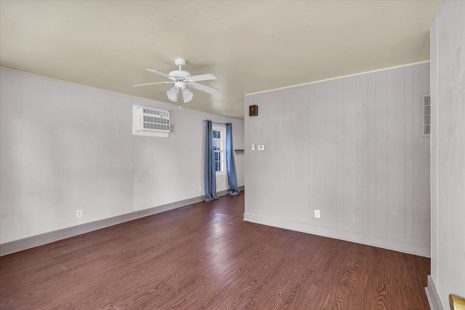 1710 Parkside Terrace Champaign, IL 61821 - Photo 6 of 31 an empty room with wooden floor ceiling fan and window