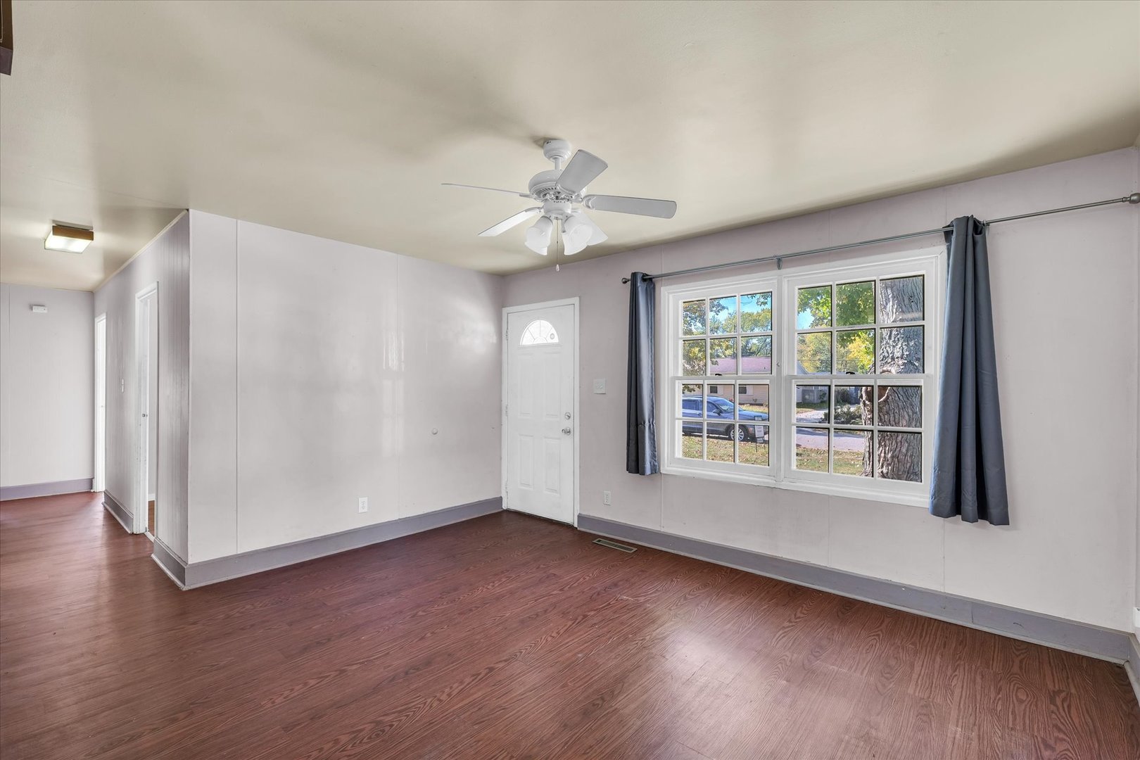 1710 Parkside Terrace Champaign, IL 61821 - Photo 7 of 31 a view of an empty room with wooden floor and a window