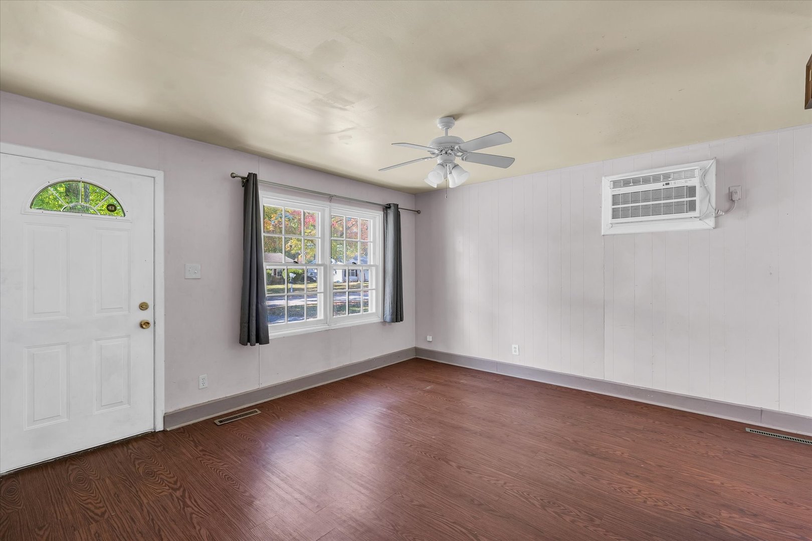 1710 Parkside Terrace Champaign, IL 61821 - Photo 8 of 31 a view of an empty room with a window and wooden floor